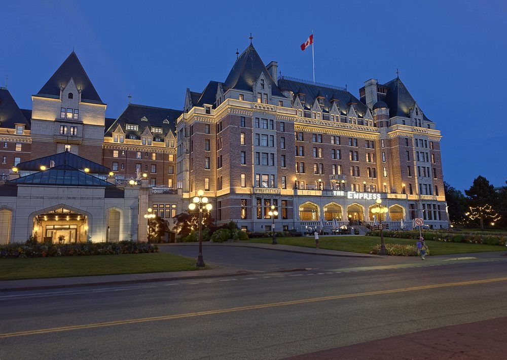 Historic grand hotel lit up at dusk